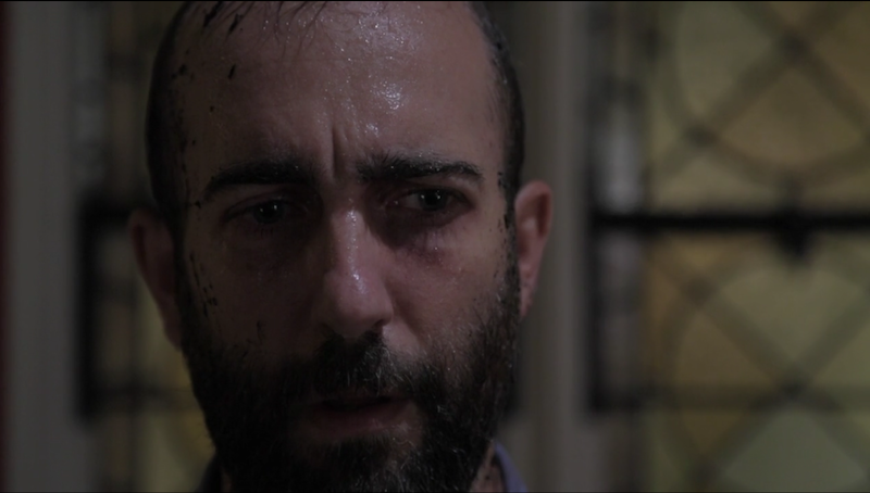 A close up of actor Andrew Dinwiddie's face. He's sweating and has a look of trepidation.